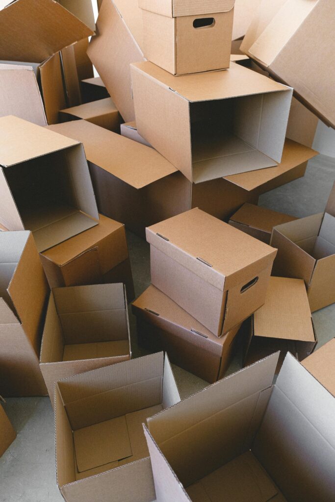 pexels-photo-7203699-7203699 A pile of empty cardboard boxes ready for packing and moving indoors.